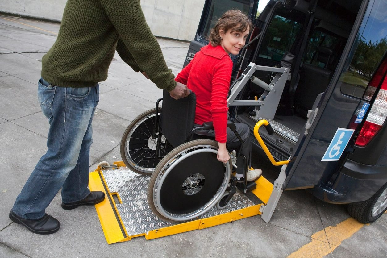 A person in a wheelchair getting into a van.